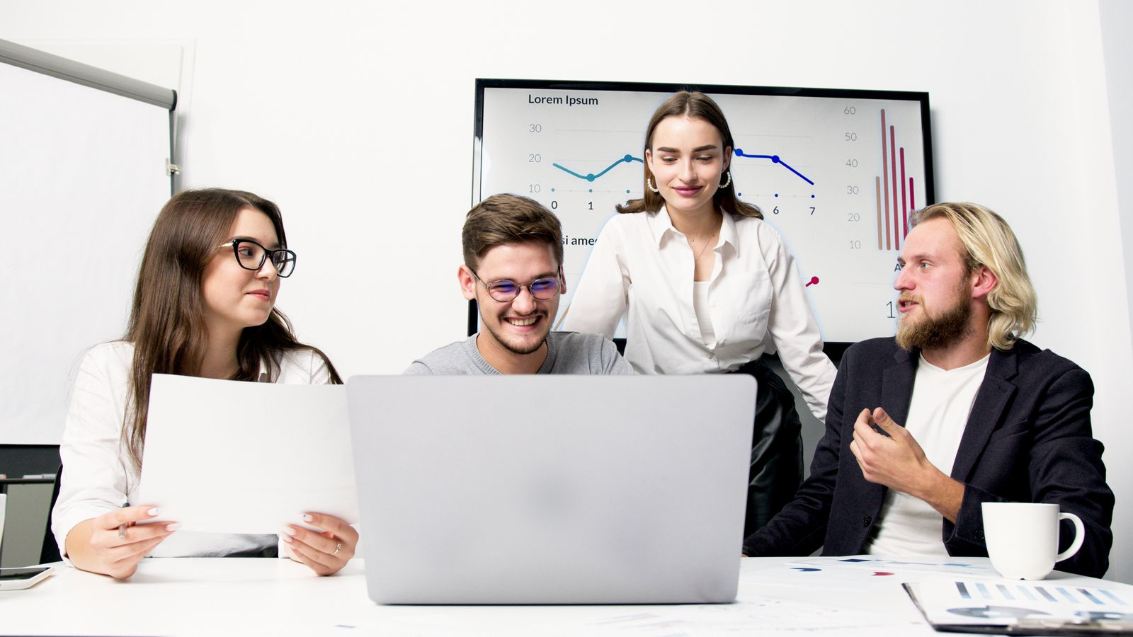Business team redesigning an AI-enabled workflow using data, charts and collaborative decision-making
